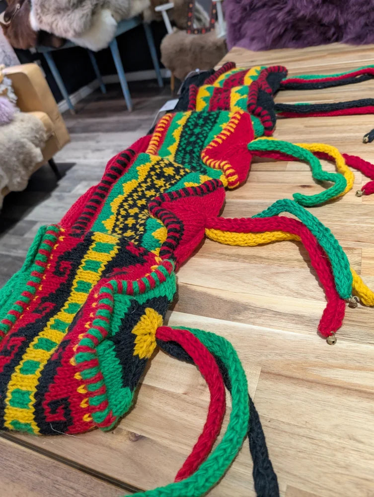 Vibrant multicolored crocheted wool hats bag with intricate patterns