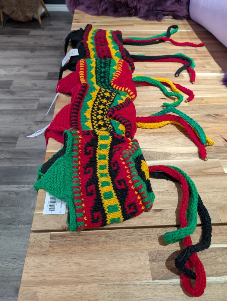 Vibrant red and green wool hats scarf with black accents, cozy sheepskin style