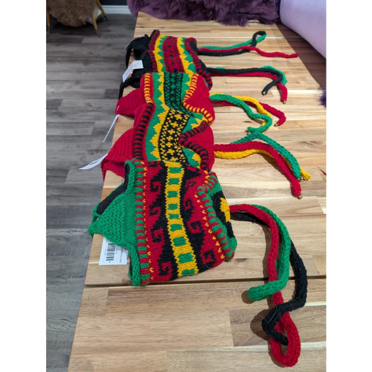 Vibrant red and green wool hats scarf with black accents, cozy sheepskin style