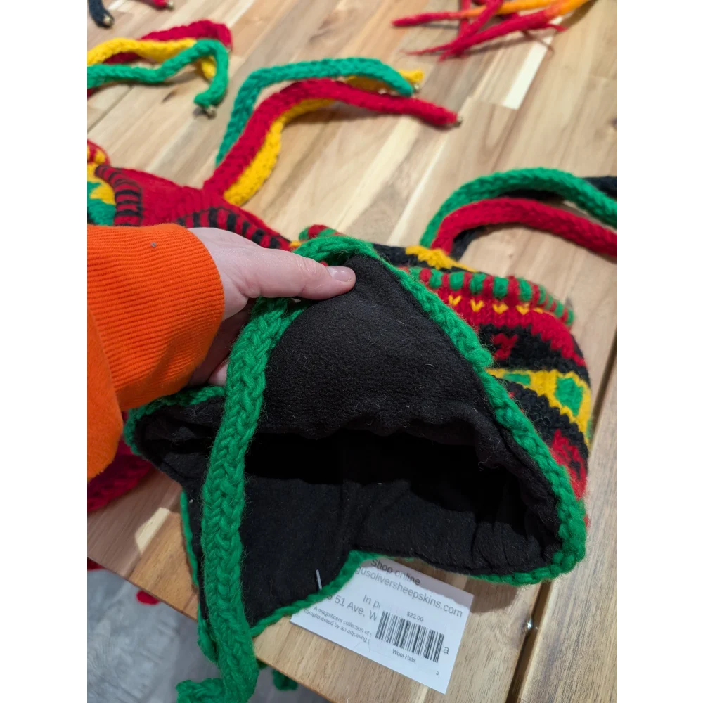 Bright multicolored wool hat with ear flaps and black lining