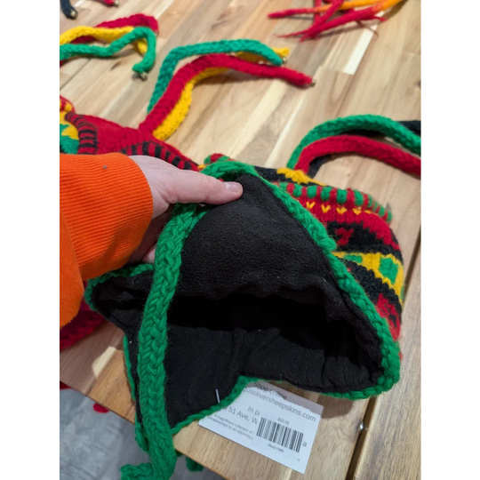 Bright multicolored wool hat with ear flaps and black lining