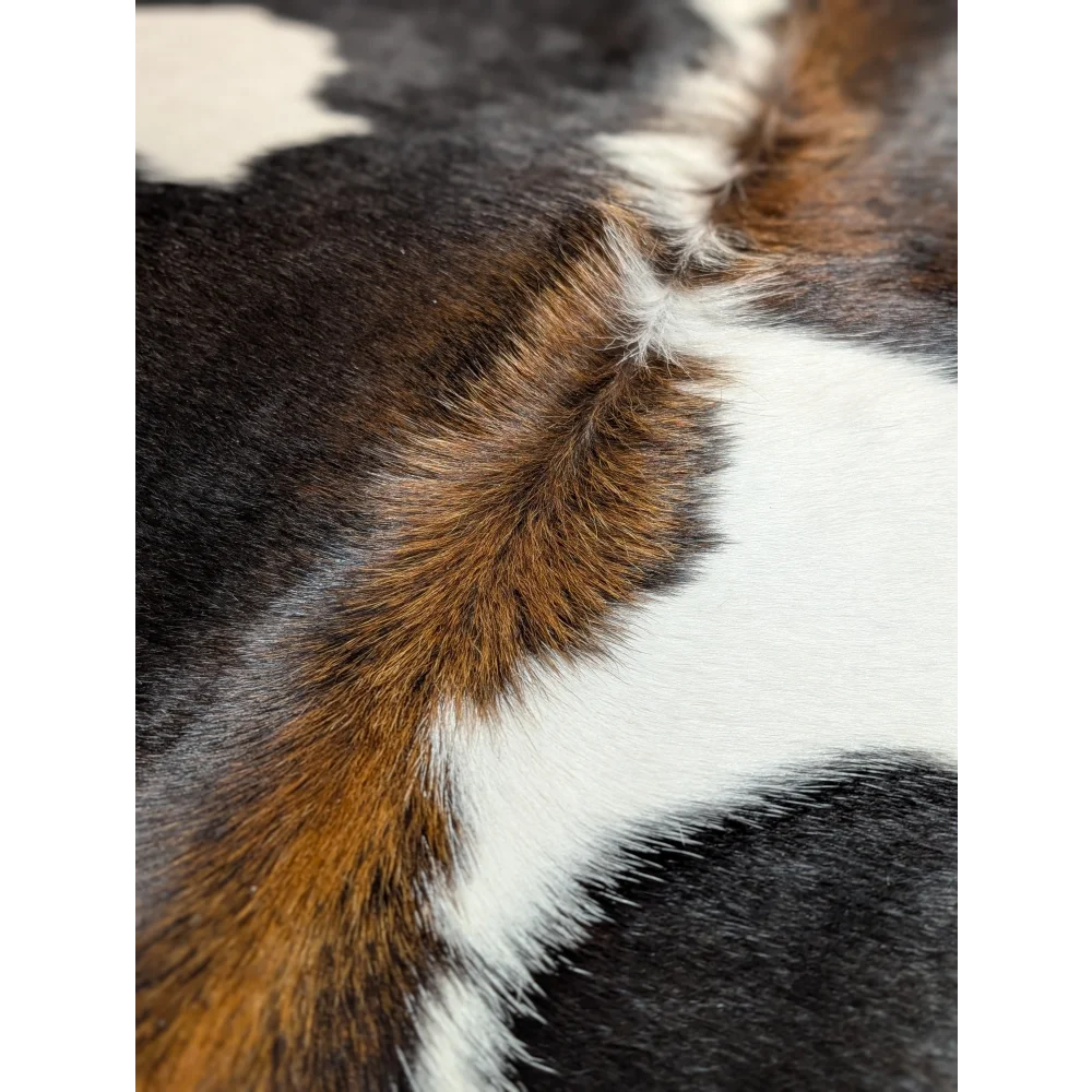 Extra large cowhide rug with black, white and brown patches, unmistakable aura