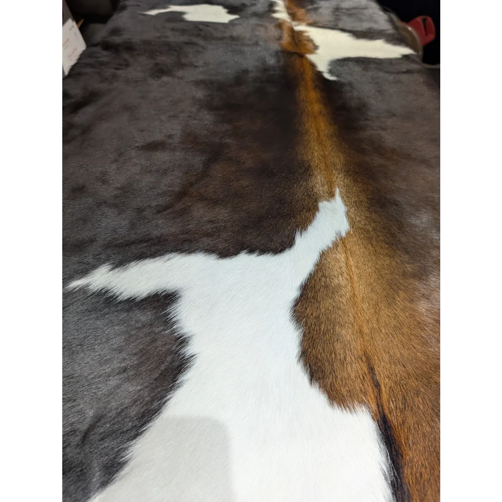 Extra large cowhide rug with brown white patches and textured natural leather aura