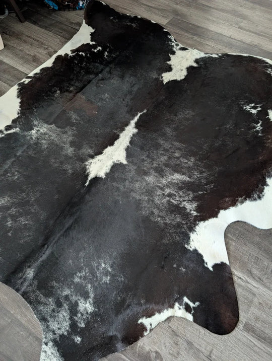 Extra large reddish black and white cowhide rug with natural fur texture large cowhide for stylish decor