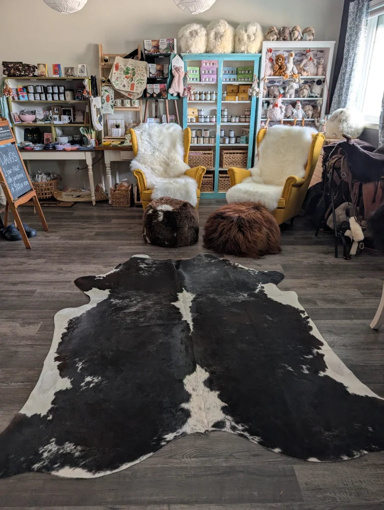 Reddish 476 extra large black and white cowhide rug with natural irregular patterns measuring 89 by 77 inches