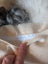 Fluffy grey sheepskin cushion with thick curly fur rug texture
