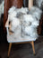 Grey sheepskin cushion throw draped on white wooden chair