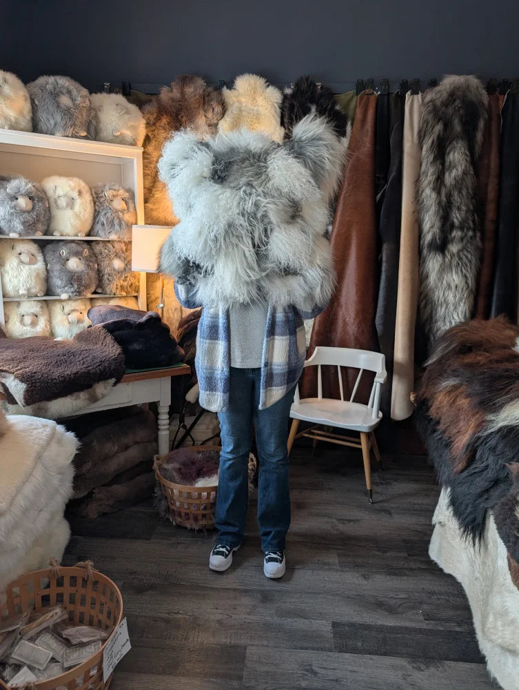 Fluffy grey sheepskin cushion with shaggy faux fur texture