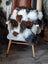 Ridiculously over the top checkered sheepskin cushion on gray chair