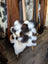Ridiculously over the top checkered sheepskin cushion on wooden chair