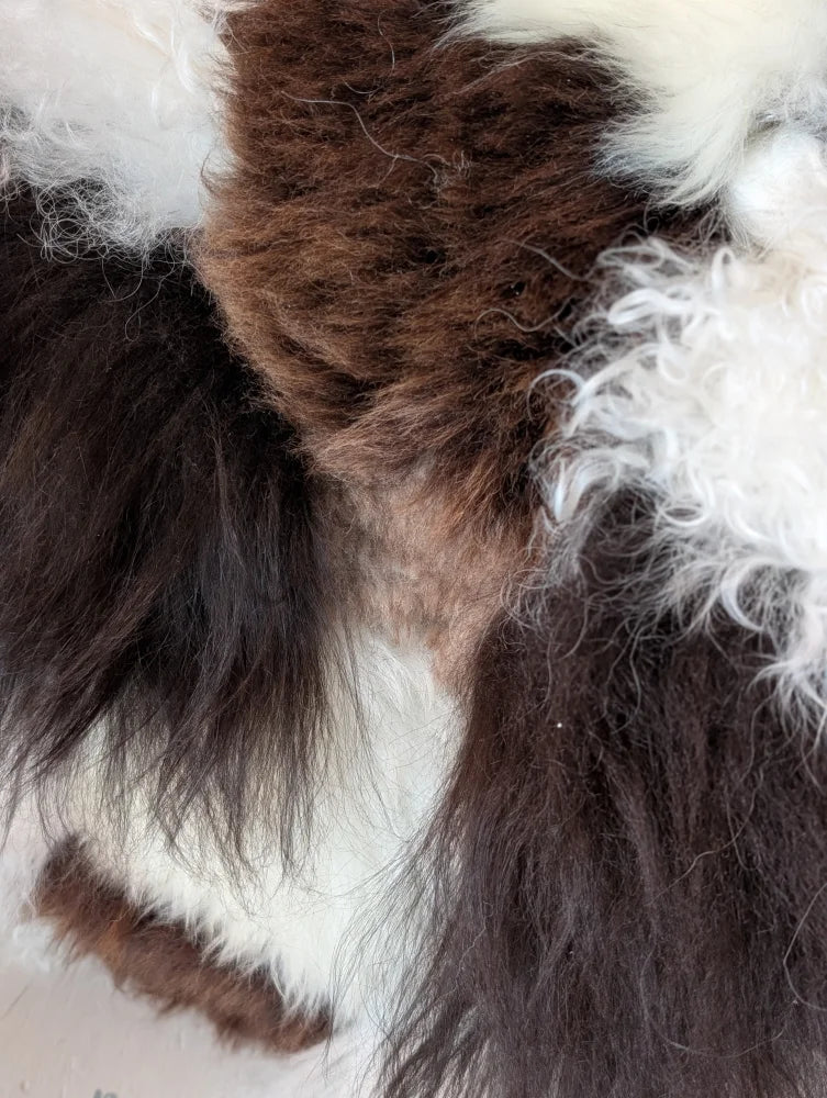 Ridiculously over the top checkered sheepskin cushion with fluffy brown white fur