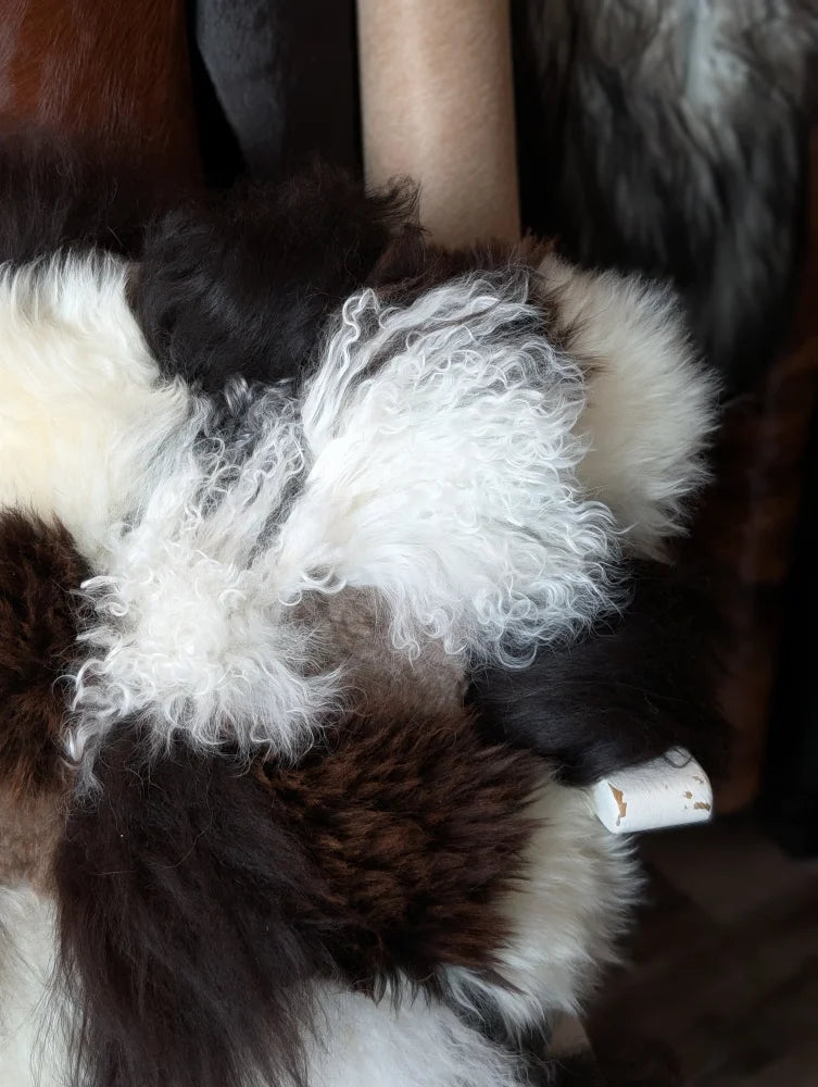 Ridiculously over the top checkered sheepskin cushion with plush curly fur