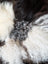 Ridiculously over the top checkered sheepskin cushion with curly white, black, gray fur rug