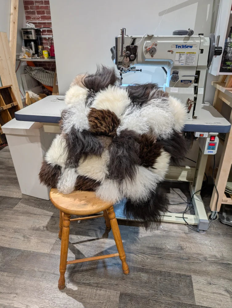 Ridiculously over the top checkered sheepskin cushion on wooden stool