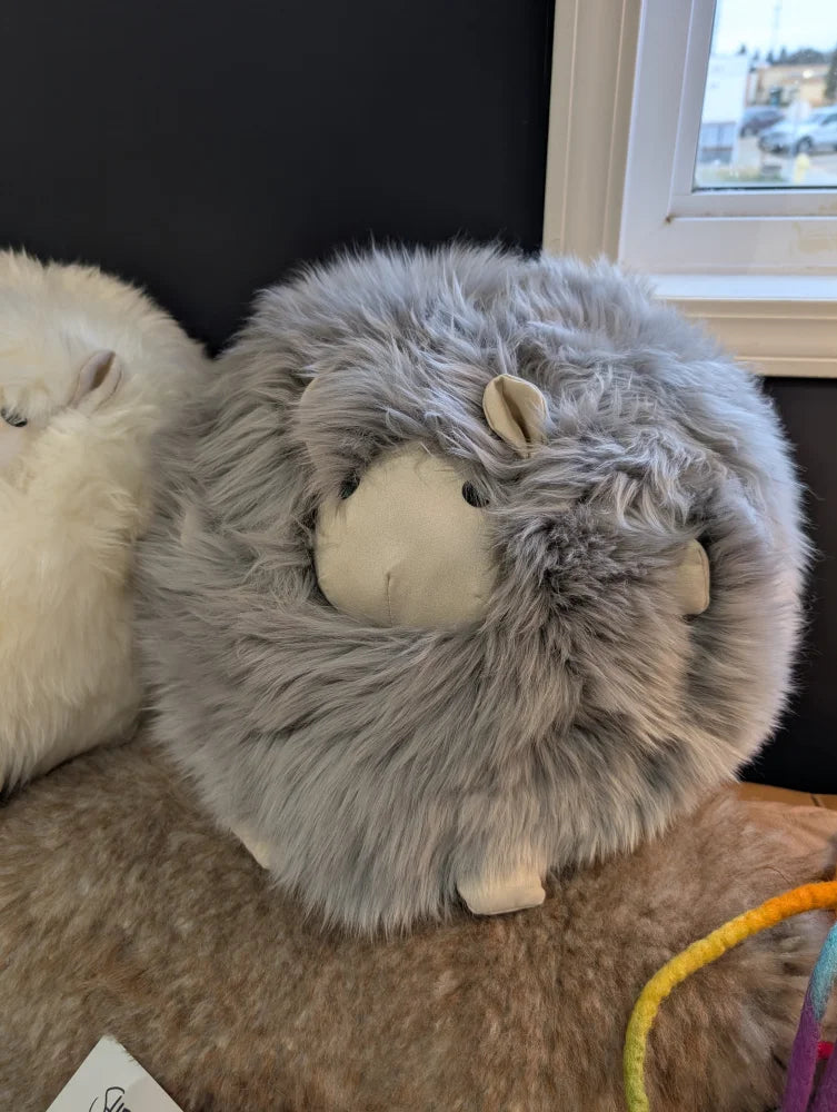 Cozy gray Rotund Sheepskin Cushion plush sheep with white face