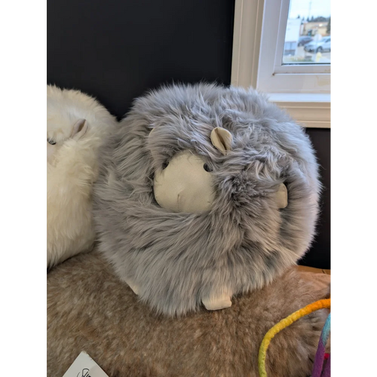 Cozy gray Rotund Sheepskin Cushion plush sheep with white face