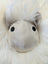 A plush white rotund sheep cushion with soft merino sheepskin fur and a satin silver face with black button eyes