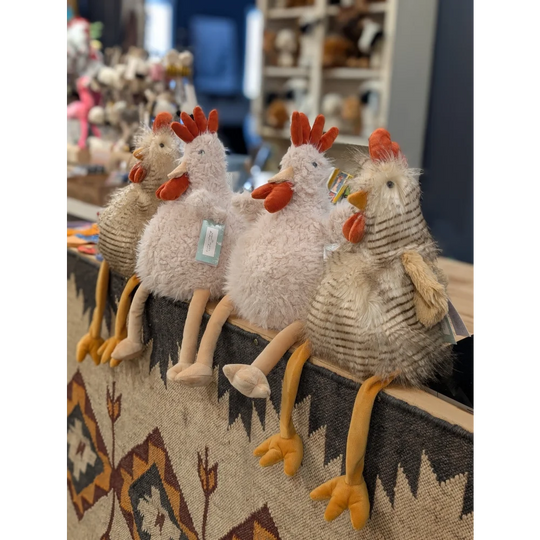 Cute white Rupert The Rooster plush by Nana Huchy on woven rug