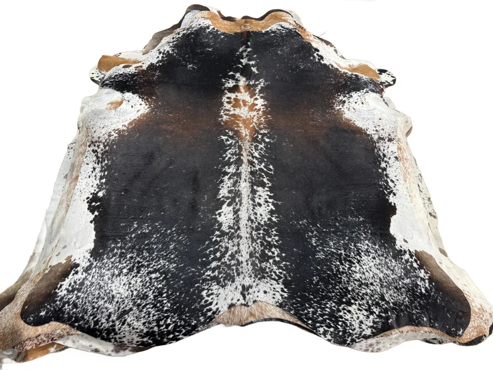 Salt & pepper brown large cowhide rug with black and white spots tan edges and a textured surface perfect for beautiful rugs