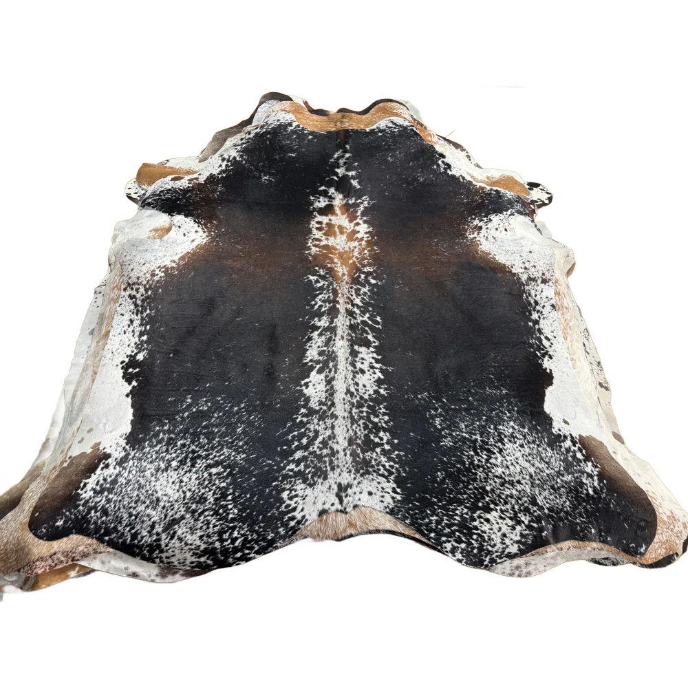 Salt &amp; pepper brown large cowhide rug with black and white spots tan edges and a textured surface perfect for beautiful rugs