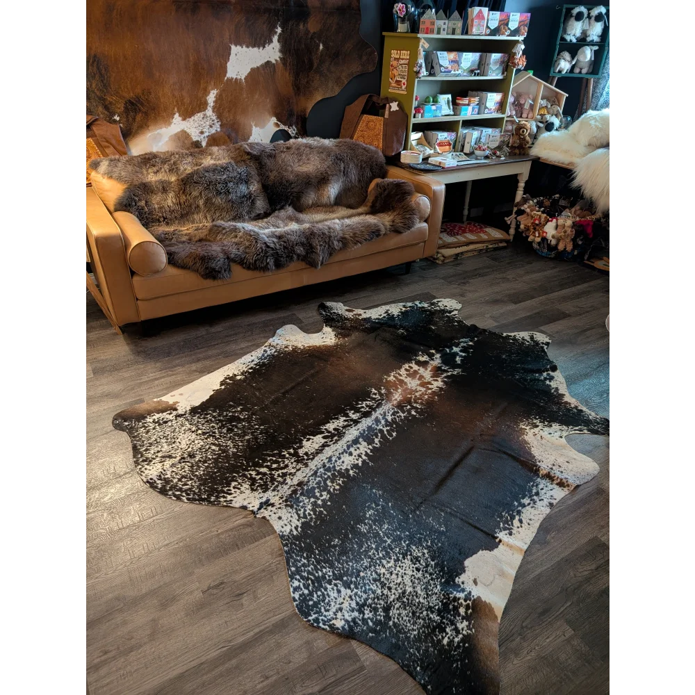 A beautiful extra large cowhide rug in salt and pepper brown with bold black white and brown pattern perfect large cowhide