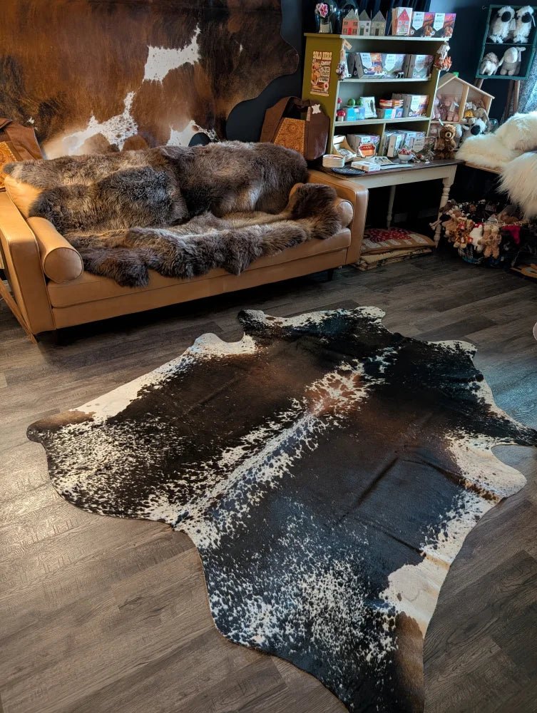 A beautiful extra large cowhide rug in salt and pepper brown with bold black white and brown pattern perfect large cowhide
