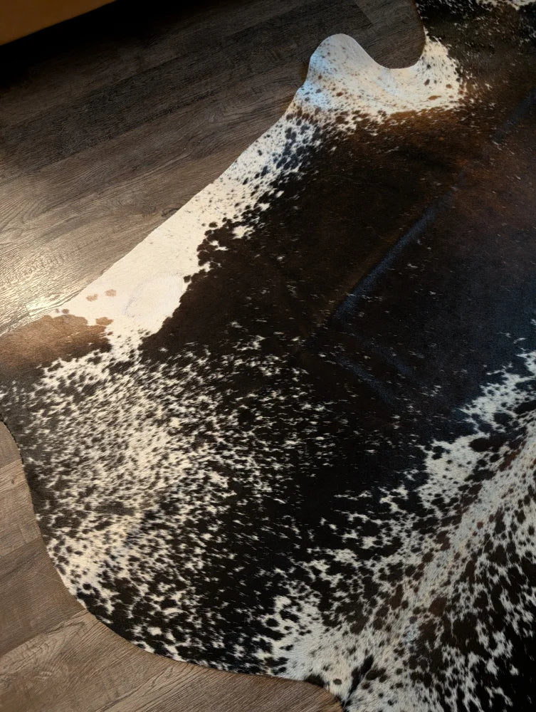 Salt and pepper brown extra large cowhide rug with black and white spots and natural irregular edges perfect for beautiful rugs
