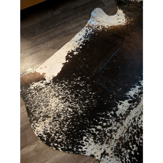 Salt and pepper brown extra large cowhide rug with black and white spots and natural irregular edges perfect for beautiful rugs