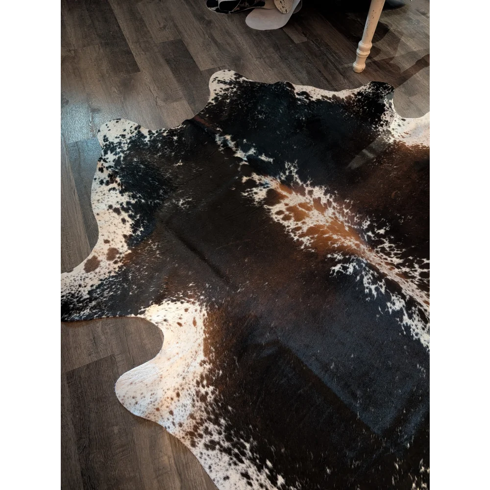 A beautiful large cowhide rug salt and pepper brown with natural black white and brown patches and realistic texture