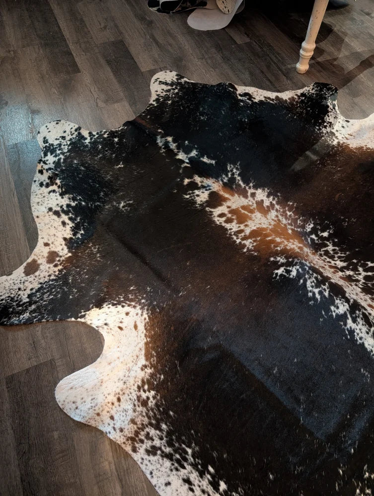 A beautiful large cowhide rug salt and pepper brown with natural black white and brown patches and realistic texture