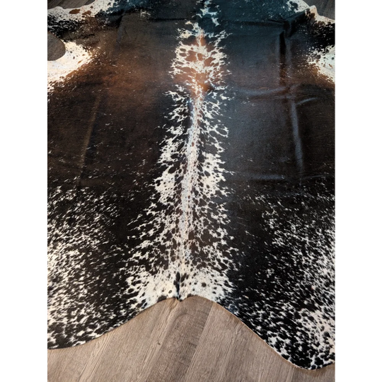 Salt and pepper brown large cowhide rug with black and white spots and natural irregular edges for beautiful rugs