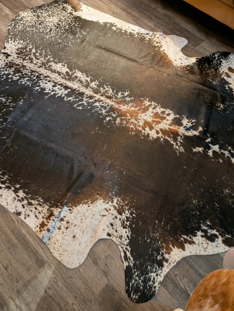Beautiful extra large cowhide rug in salt and pepper brown with natural irregular patterns perfect for large cowhide decor