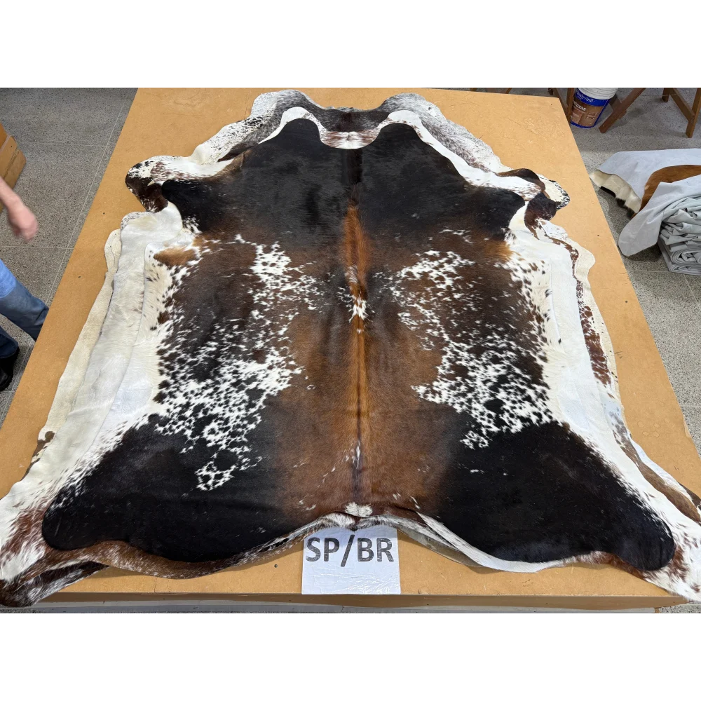 Spotted black, white, and brown cowhide rug perfect for making beautiful cowhides make