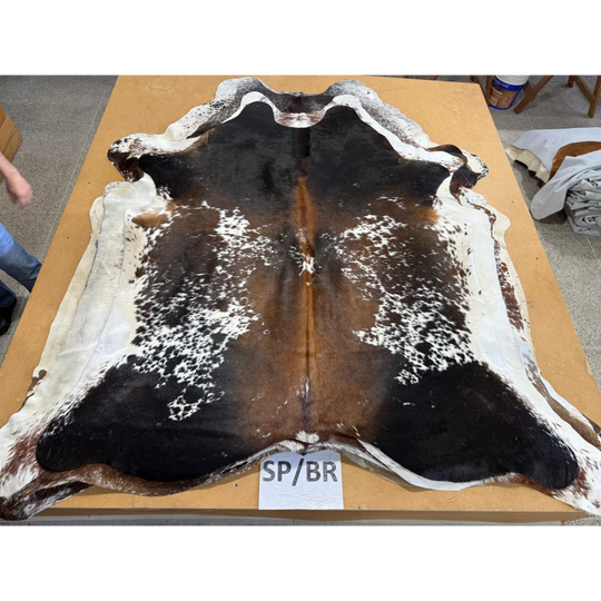 Spotted black, white, and brown cowhide rug perfect for making beautiful cowhides make