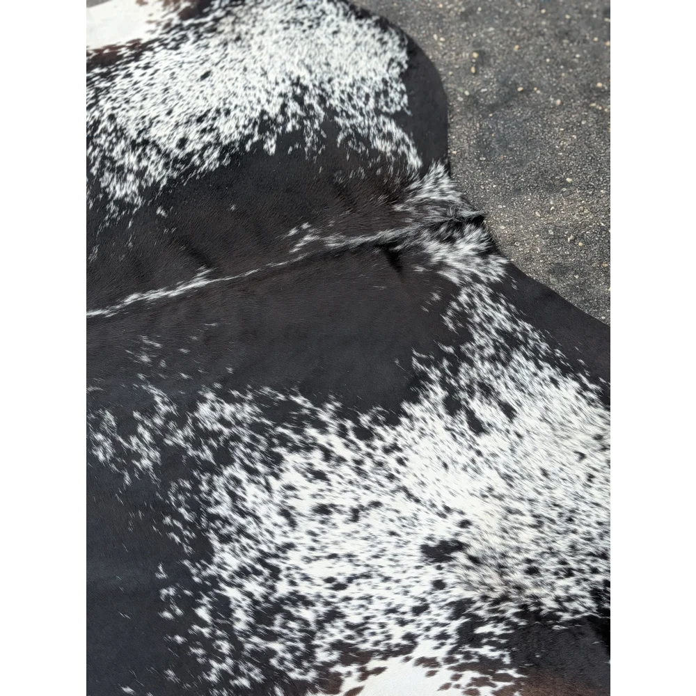 Black and white extra large cowhide rug with speckled pattern from a premium leather brand