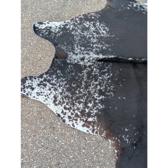 Black and white extra large cowhide rug with speckled pattern and leather texture