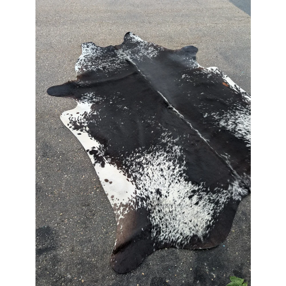 Salt & Pepper Tri extra large cowhide rug with black and white spots and natural leather texture