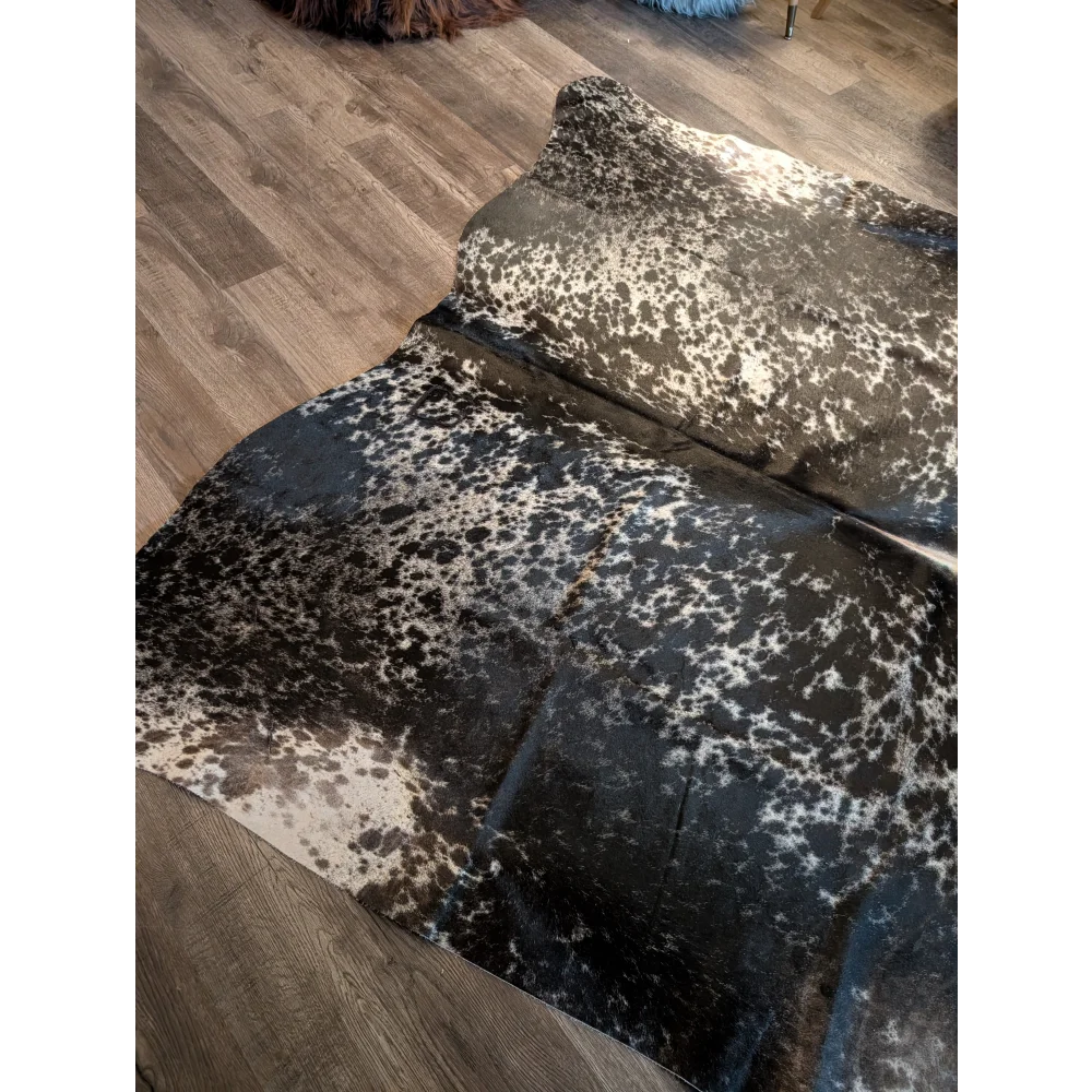 Beautiful extra large cowhide salt and pepper tricolour rug with black and white spots and a natural textured surface