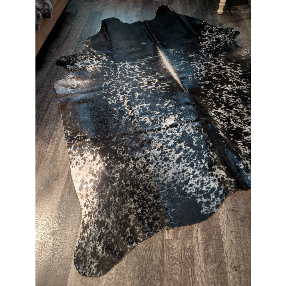 Beautiful extra large cowhide rug in salt and pepper tricolour with black and white spots and natural edges