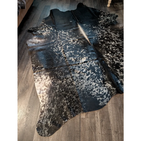 Beautiful extra large cowhide rug in salt and pepper tricolour with black and white spots and natural edges