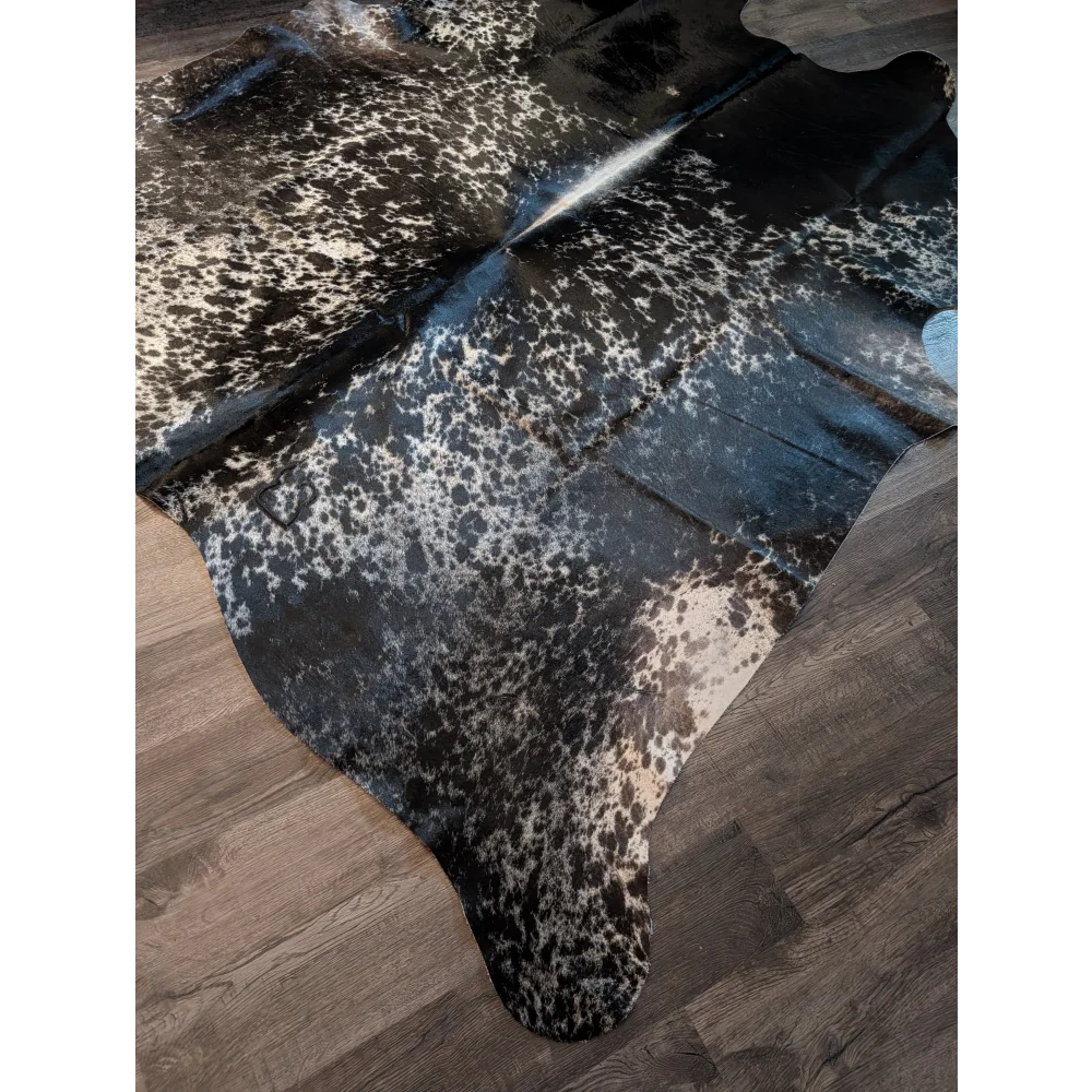 Large extra large cowhide rug with black and white spots and glossy finish perfect for beautiful rugs lovers