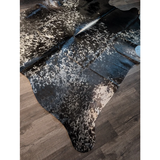 Large extra large cowhide rug with black and white spots and glossy finish perfect for beautiful rugs lovers