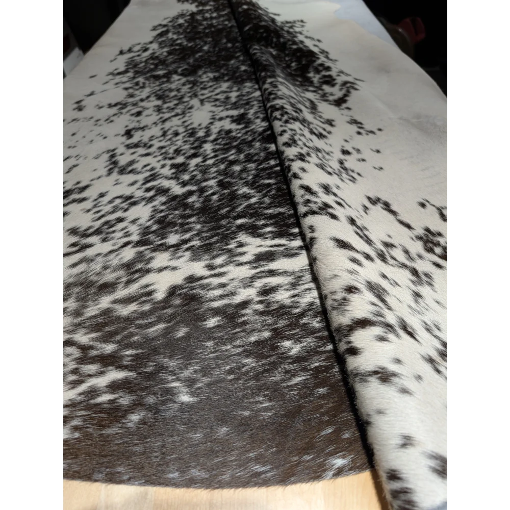 Extra large cowhide rug with black and white speckled leather texture, unmistakable aura