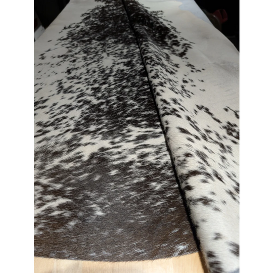 Extra large cowhide rug with black and white speckled leather texture, unmistakable aura
