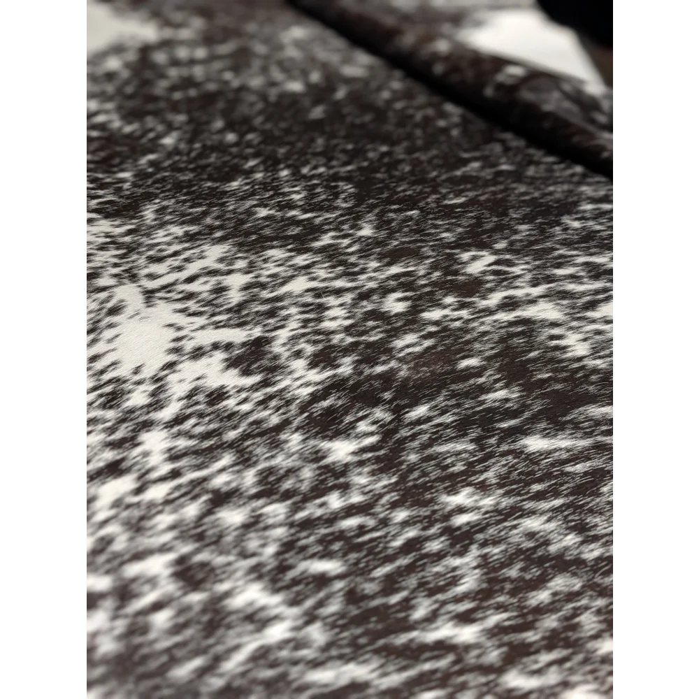 Extra large cowhide rug with black and white speckled texture and unmistakable aura