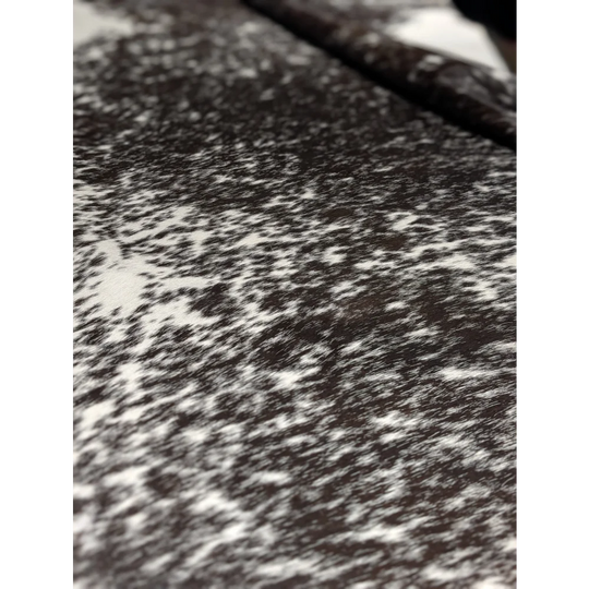 Extra large cowhide rug with black and white speckled texture and unmistakable aura