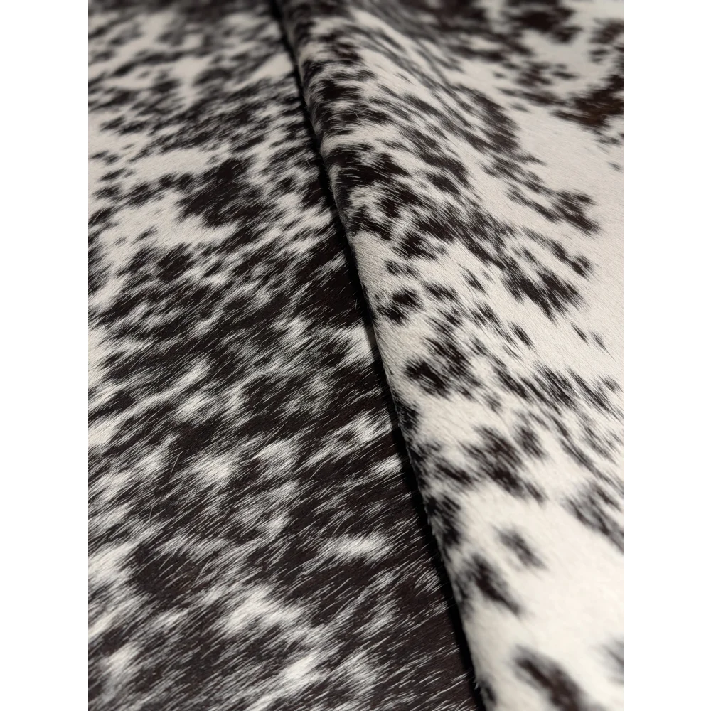Extra large cowhide rug with black white speckled texture and unmistakable aura