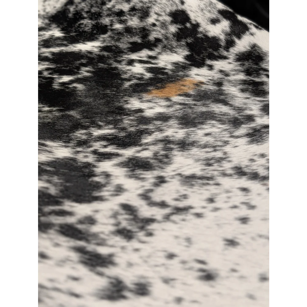 Extra large cowhide rug with black white speckles and orange accents, soft underfoot, 81.5x73in