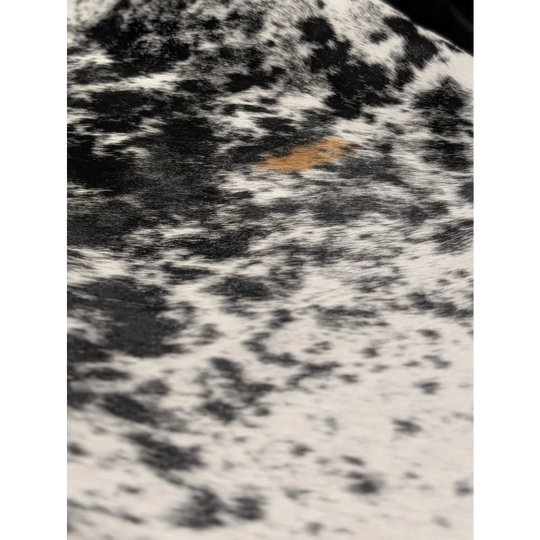 Extra large cowhide rug with black white speckles and orange accents, soft underfoot, 81.5x73in