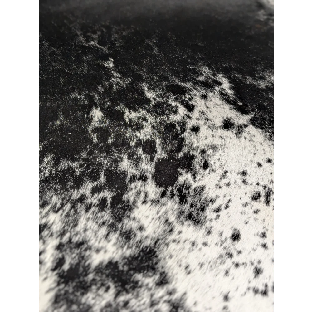 Extra large black and white cowhide rug with abstract patterned texture, soft underfoot